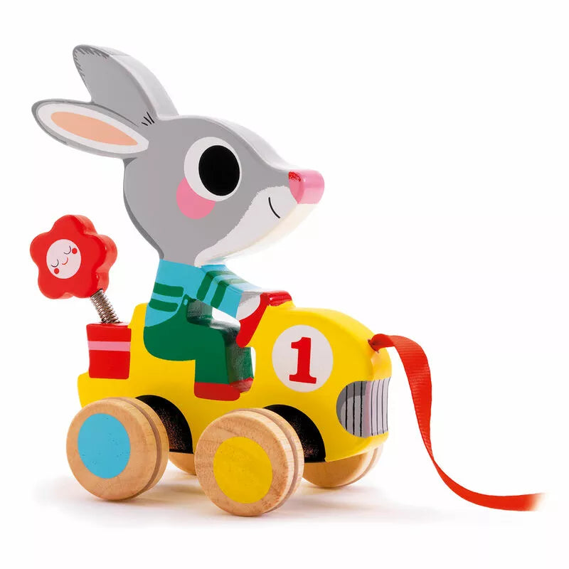 A Djeco Pull along Roulapic wooden toy car with a rabbit on top of it.