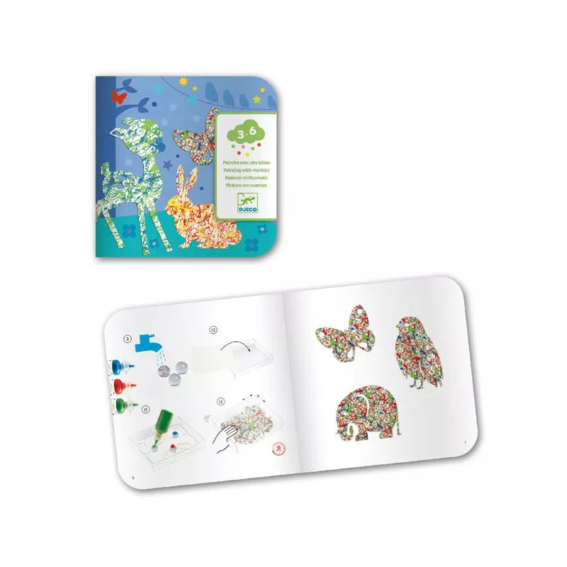 An open Djeco Painting with Marbles Colourful Parade book with a picture of a giraffe.