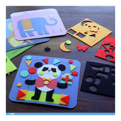 A Djeco table topped with lots of Djeco Felt Collages Gentle creatures cut outs and magnets.